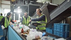Workers sorting plastic for recycling.