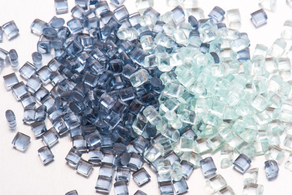 two different polymer plastic granulates on white background