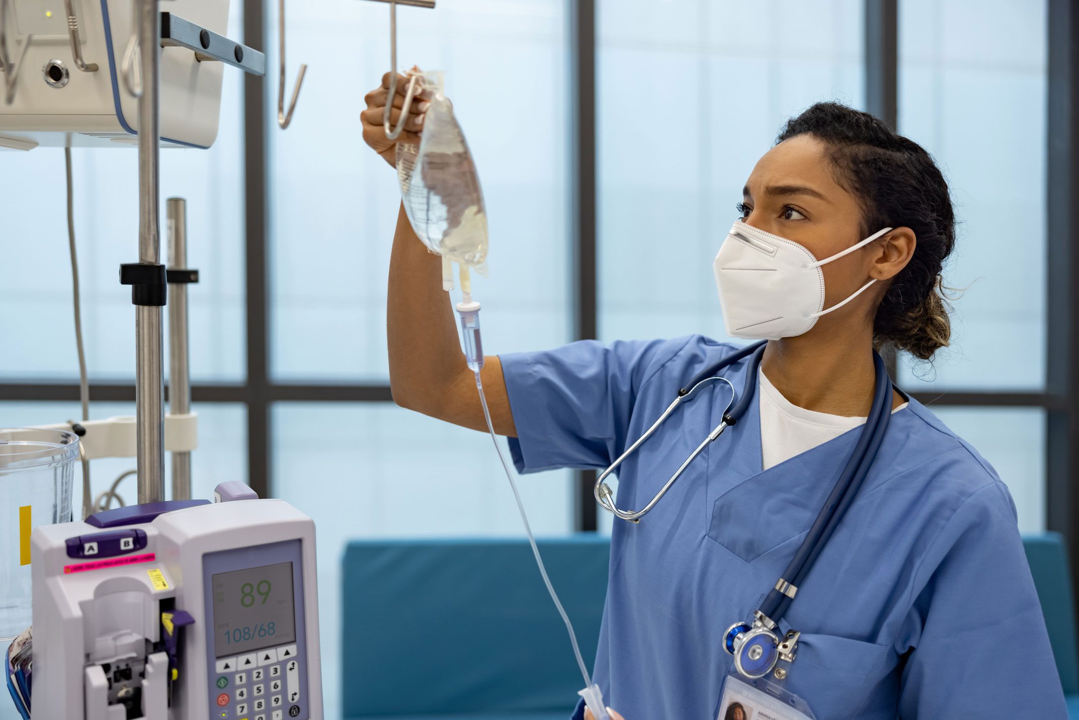 Nurse handling fluid bag for IV.
