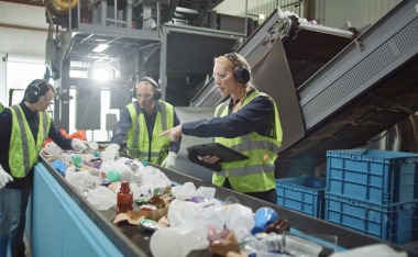Workers sorting plastic for recycling.