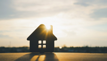 Wooden House with sun flare.