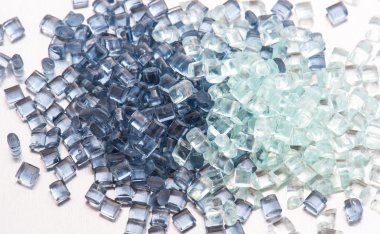 two different polymer plastic granulates on white background